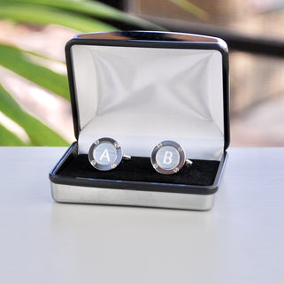 Silver porthole cufflinks shown in silver rectangle chrome cufflinks box