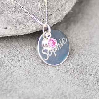 Necklace with personalised name "Sophie" engraved on silver circle disc with Alexandrite/June birthstone shown on close up shot