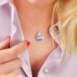 Necklace with personalised name "Sophie" engraved on silver circle disc with Alexandrite/June birthstone shown on close up shot on model