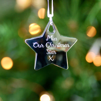 Christmas Star Tree Decoration with Personalised message "Mia Our Christmas Star X" engraved on the front shown in close up shot on Christmas tree