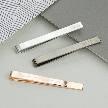 Tie slides shown in 3 polished metal colours with personalised messages on the front and back.