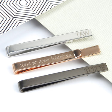 Tie slides shown in 3 polished metal colours with personalised messages on the front and back.
