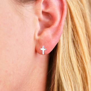 Sterling Silver Tiny Cross Stud Earrings shown on close up of model