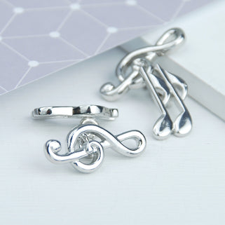 Treble clef music note cufflinks shown in close up shot