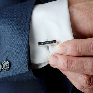 Silver wedding bar cufflinks with rose gold tips with "Tomorrow" engraved on the front. Shown in close up shot on men's shirt sleeve.