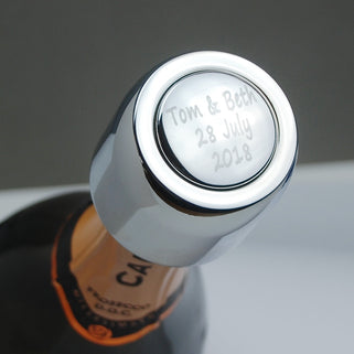 Prosecco Bottle Stopper with "Tom & Beth 28 July 2028" message engraved shown on prosecco bottle