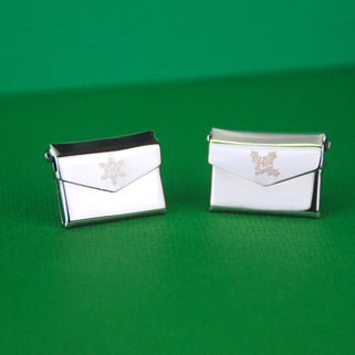 Christmas Card Message Pins, snowflake engraved on the front of left envelope and holly engraved on the front of right pin