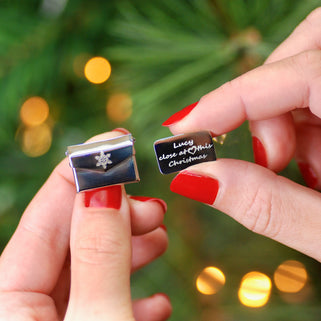 Christmas Card Message Pin with snowflake engraved on the front of envelope and "Lucy close at heart this Christmas" engraved on letter shown in close up shot held by model